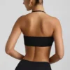 Braletă Jerika din jersey elastic cu detalii metalice și gât halter, în negru Braletă Jerika din jersey elastic cu detalii metalice și gât halter, în negru
