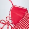 Costum de baie întreg cu decupaje și volane Montjoi, cu gât halter, în carouri roșii Costum de baie întreg cu decupaje și volane Montjoi, cu gât halter, în carouri roșii