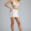 Fustă mini Joni cu talie medie și ornamente, în culoarea Ivory Fustă mini Joni cu talie medie și ornamente, în culoarea Ivory