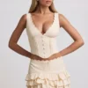 Fustă mini plisată în straturi, cu talie joasă, Lorena, în culoarea fildeș Fustă mini plisată în straturi, cu talie joasă, Lorena, în culoarea fildeș