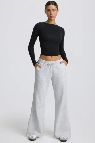 Pantaloni de jogging cu talie joasă și croi larg, în culoarea gri melanj Pantaloni de jogging cu talie joasă și croi larg, în culoarea gri melanj