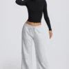 Pantaloni de jogging cu talie joasă și croi larg, în culoarea gri melanj Pantaloni de jogging cu talie joasă și croi larg, în culoarea gri melanj