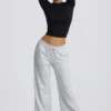 Pantaloni de jogging cu talie joasă și croi larg, în culoarea gri melanj Pantaloni de jogging cu talie joasă și croi larg, în culoarea gri melanj
