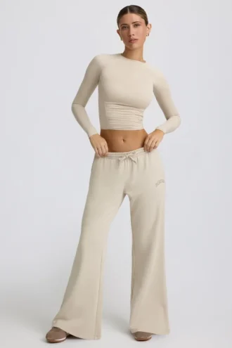 Pantaloni de jogging cu talie joasă și picior larg, în culoarea Bone Pantaloni de jogging cu talie joasă și picior larg, în culoarea Bone