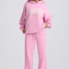 Pantaloni de jogging din jersey de bumbac moale, cu talie medie și croi larg, în roz pal Pantaloni de jogging din jersey de bumbac moale, cu talie medie și croi larg, în roz pal