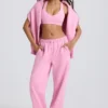 Pantaloni de jogging din jersey de bumbac moale, cu talie medie și croi larg, în roz pal Pantaloni de jogging din jersey de bumbac moale, cu talie medie și croi larg, în roz pal