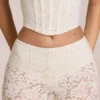 Pantaloni evazați din dantelă transparentă, cu talie medie, model Calista, culoare ivoriu Pantaloni evazați din dantelă transparentă, cu talie medie, model Calista, culoare ivoriu