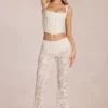 Pantaloni evazați din dantelă transparentă, cu talie medie, model Calista, culoare ivoriu Pantaloni evazați din dantelă transparentă, cu talie medie, model Calista, culoare ivoriu