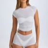 Pantaloni scurți transparenți cu volane Rocas, de culoare albă