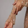 Rochie de seară Isabeau cu mâneci lungi, transparentă și decorată, în culoarea Almond Rochie de seară Isabeau cu mâneci lungi, transparentă și decorată, în culoarea Almond