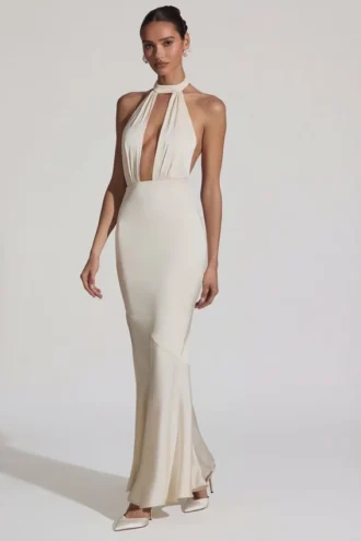 Rochie lungă Desiree cu spate decupat, gât halter și croi în formă de coadă de pește, în culoarea ivoriu Rochie lungă Desiree cu spate decupat, gât halter și croi în formă de coadă de pește, în culoarea ivoriu