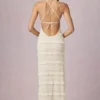 Rochie maxi Tove cu volane, fără spate și cu gât halter, în culoarea Ivory Rochie maxi Tove cu volane, fără spate și cu gât halter, în culoarea Ivory
