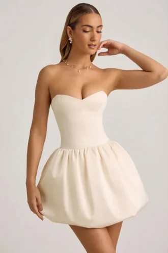 Rochie midi-ax Gloriana convertibilă, cu detaliu fundă și tiv bufant, în culoarea ivoriu Rochie midi-ax Gloriana convertibilă, cu detaliu fundă și tiv bufant, în culoarea ivoriu
