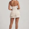 Rochie mini asimetrică cu gât halter și straturi, model Rosaria, în culoarea ivoriu