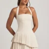 Rochie mini asimetrică cu gât halter și straturi, model Rosaria, în culoarea ivoriu