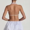 Rochie mini Cece cu decupaje și tiv bufant, în alb