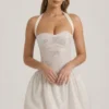 Rochie mini Felicity cu decolteu halter și tiv bufant, decorată, în culoarea ivoriu Rochie mini Felicity cu decolteu halter și tiv bufant, decorată, în culoarea ivoriu