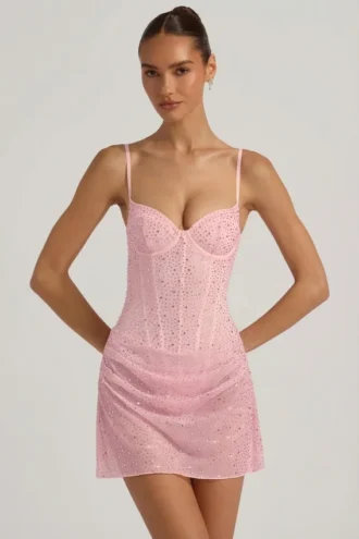 Rochie mini semi-transparentă, drapată, cu corset și ornamente, model Connie, în roz Rochie mini semi-transparentă, drapată, cu corset și ornamente, model Connie, în roz