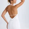 Rochie mini Vella cu guler înalt și spate decupat, de culoare albă Rochie mini Vella cu guler înalt și spate decupat, de culoare albă