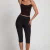 Top Armelia cu guler cowl și decupaje, în negru Top Armelia cu guler cowl și decupaje, în negru