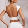 Top scurt cu mâneci scurte și spate decupat Juno, în culoarea alb Top scurt cu mâneci scurte și spate decupat Juno, în culoarea alb